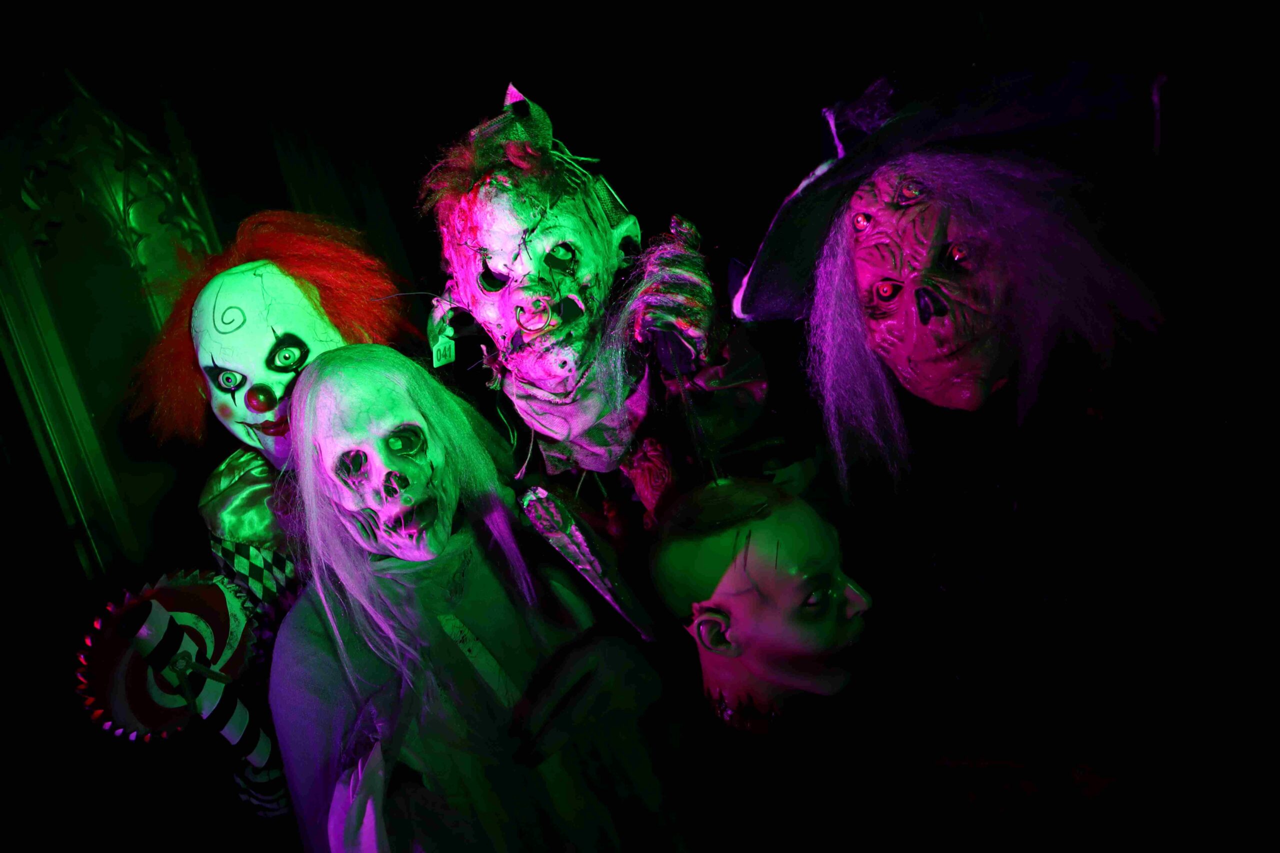 A group of Halloween characters including clown, zombie and witch