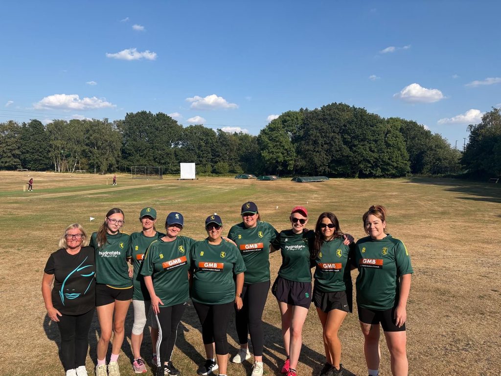 A group of women cricket players on the cricket field